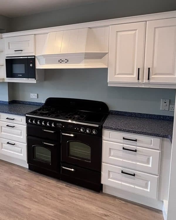 The same kitchen cabinets resprayed white by EF